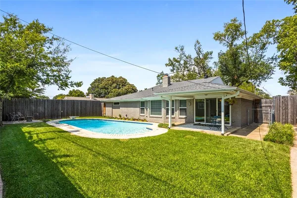 a view of a house with a yard deck and a patio