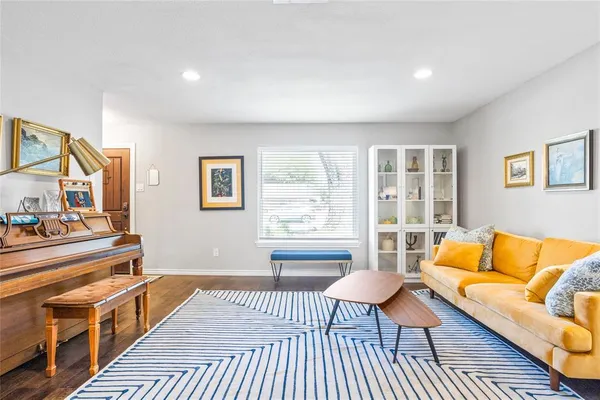 a living room with furniture and a rug