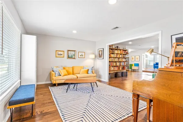 a white bed sitting in a bedroom next to a lamp