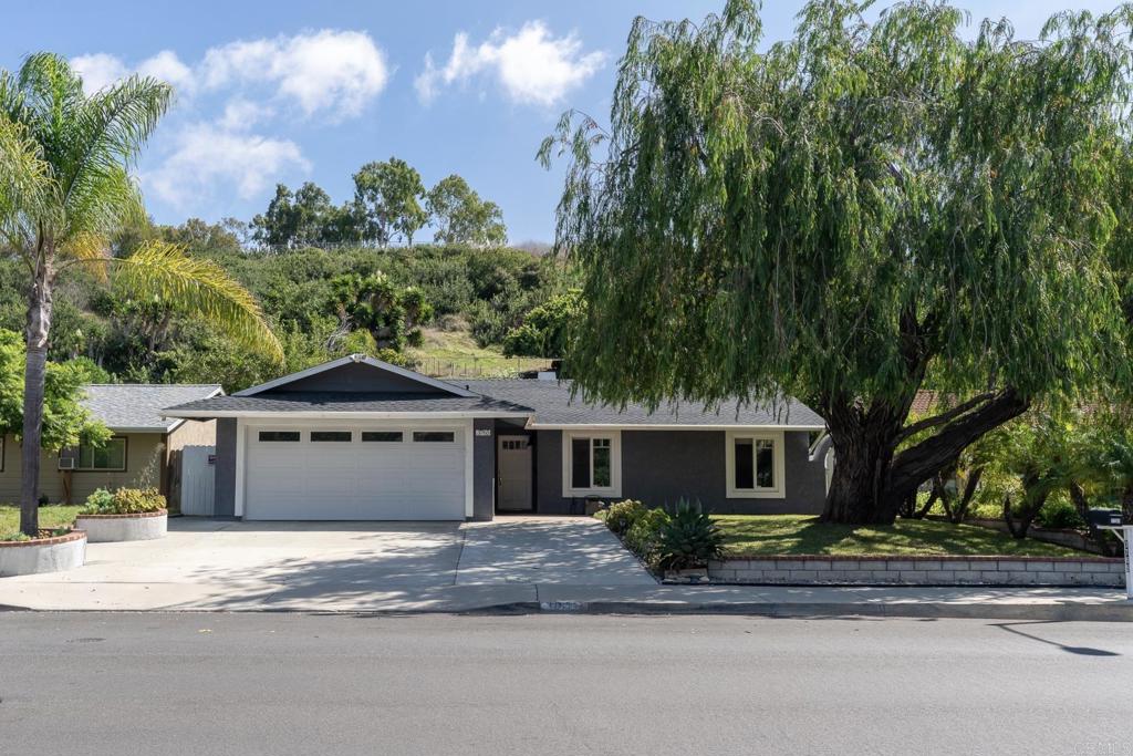 3765 Cameo Drive Oceanside, CA 92056 - Photo 1 of 37 a front view of a house with a garden and trees