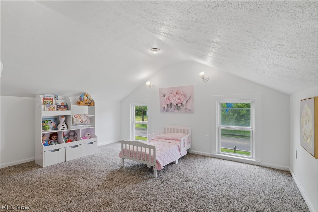 5860 Kirk Road Canfield, OH 44406 - Photo 15 of 17 Room featuring sloped ceilings, two windows, wall sconces, and recessed lighting