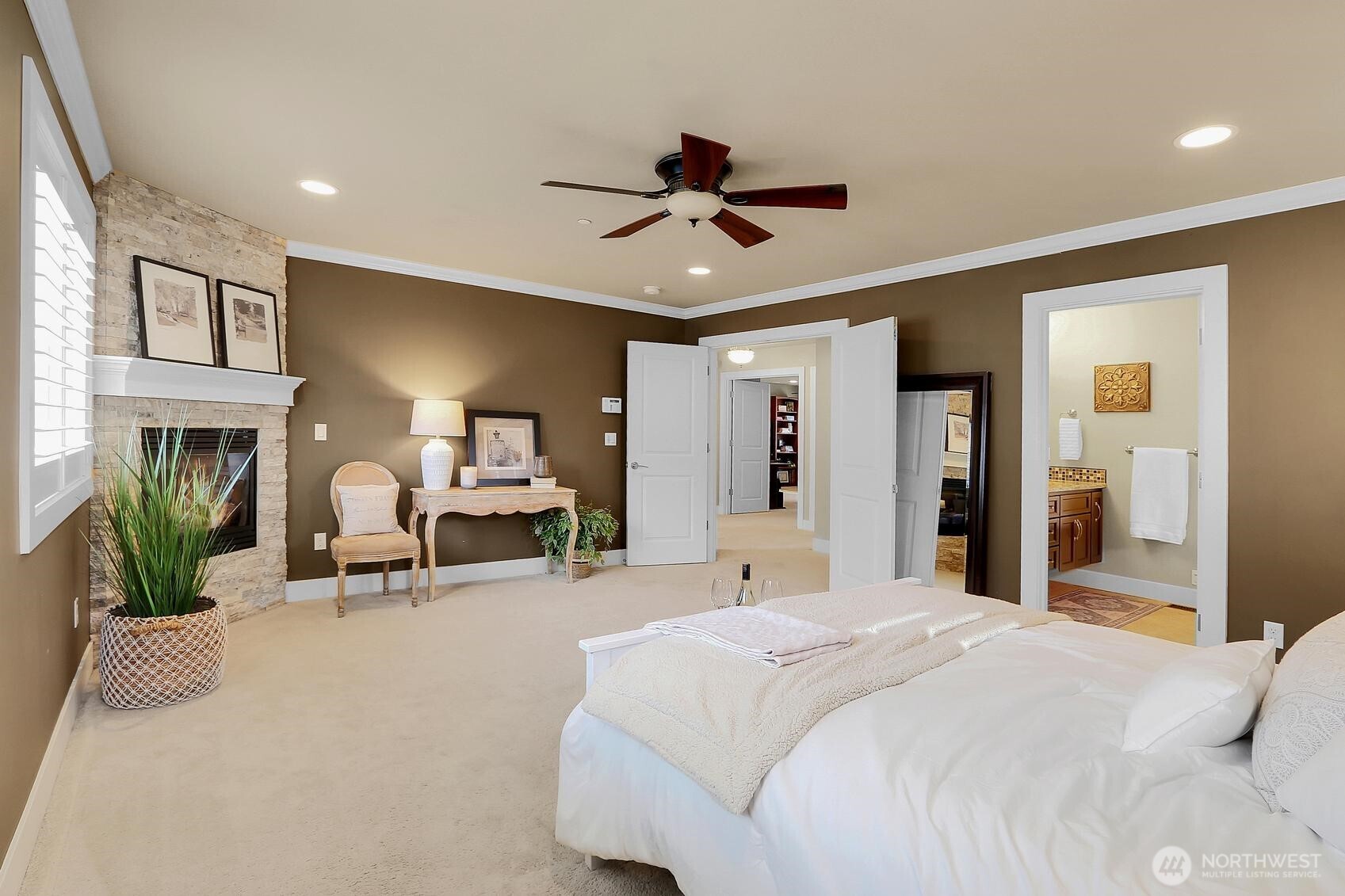 2307 242nd Place Southwest Bothell, WA 98021 - Photo 18 of 32 a bedroom with a bed mirror and a ceiling fan