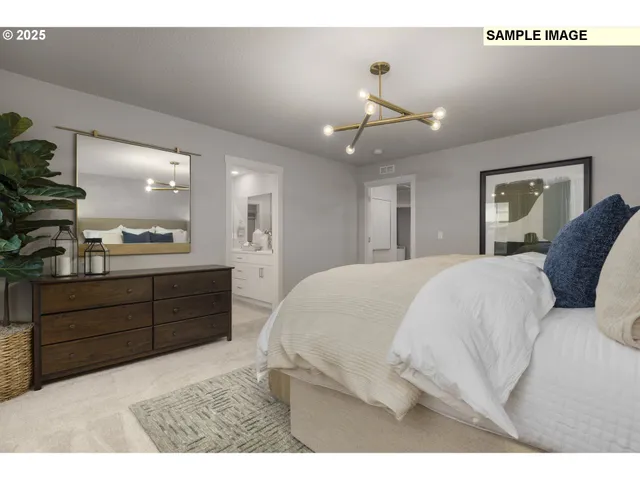 a large bedroom with a large bed and chandelier