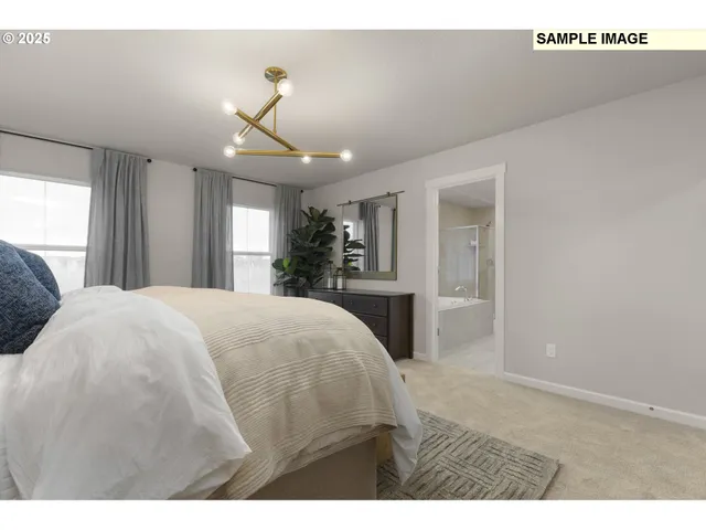 a spacious bedroom with a bed and a chandelier