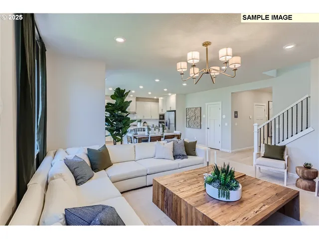 a living room with furniture kitchen and a chandelier