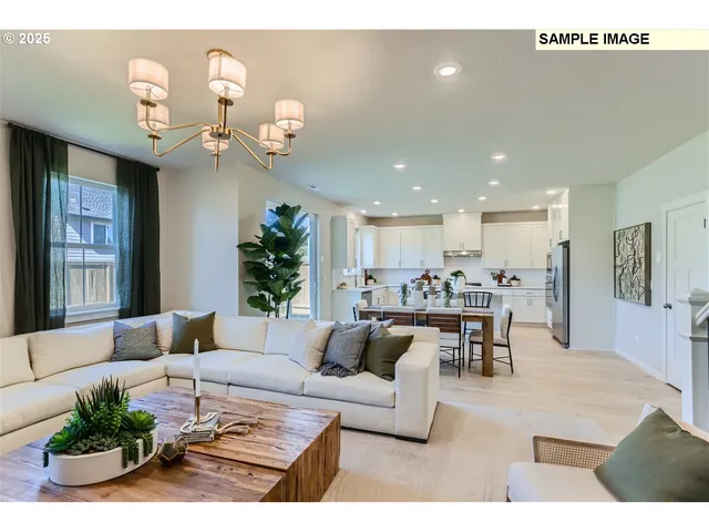 a living room with furniture kitchen view and a chandelier