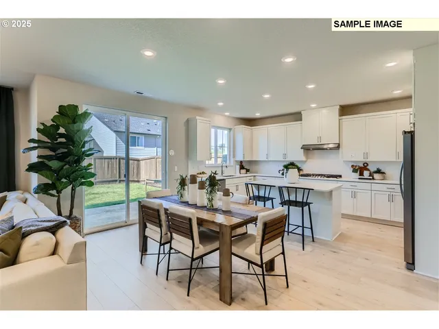 a kitchen with granite countertop white cabinets a counter and chairs