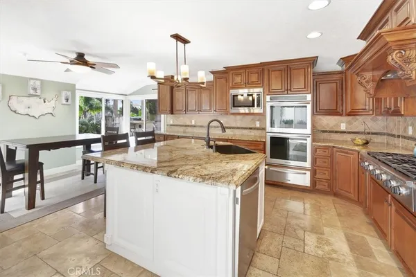 a kitchen with stainless steel appliances granite countertop a sink and cabinets