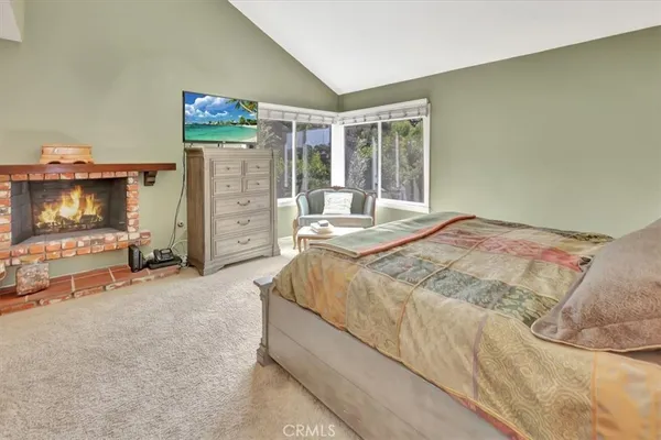 a spacious bedroom with a bed and a window