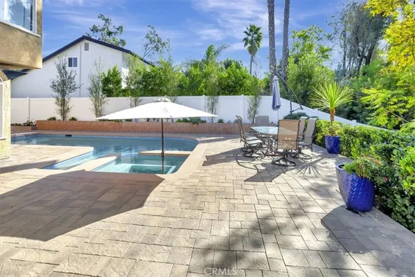 a view of a patio with table and chairs potted plants