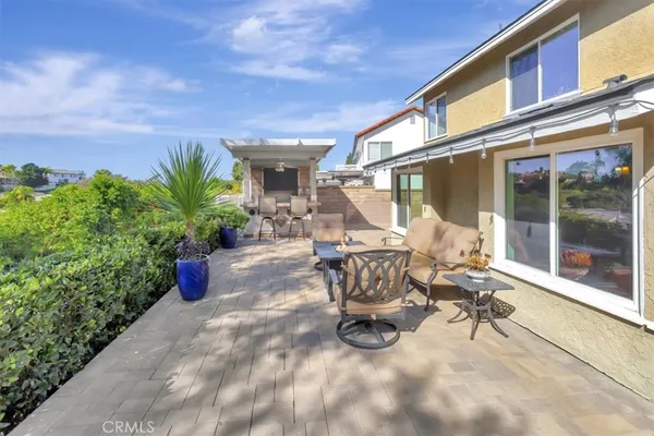 a view of a patio with table and chairs and potted plants