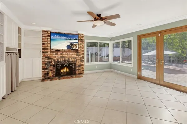 a view of an empty room with window and fireplace