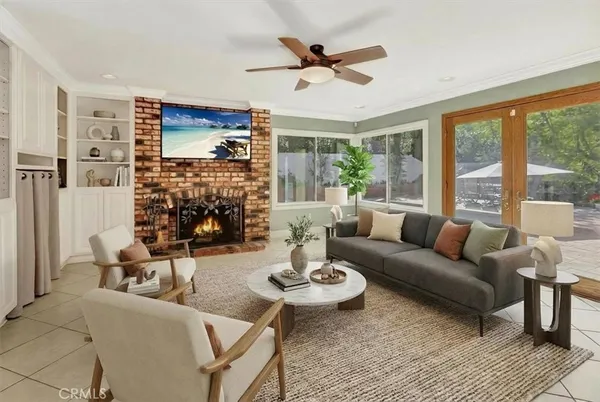 a living room with fireplace furniture and a large window