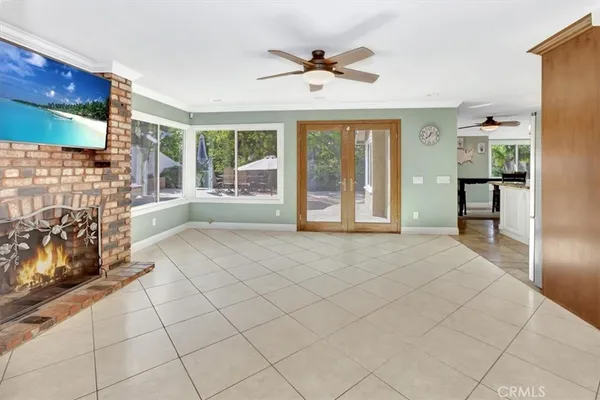 a view of an empty room with a fireplace and a window