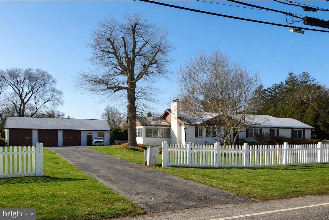 a view of a house with a yard and porch