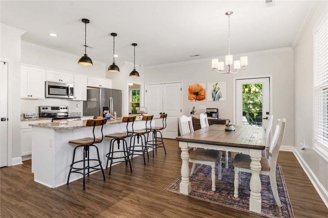 47 A Main Street Pelzer, SC 29669 - Photo 13 of 27 This open concept kitchen and dining area features modern amenities and abundant natural light.