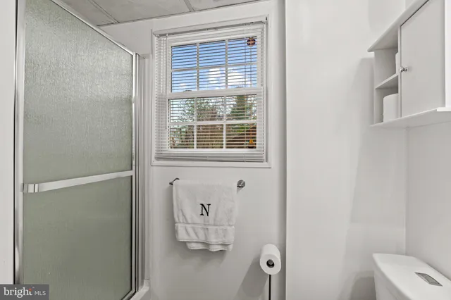 a bathroom with a window and a shower