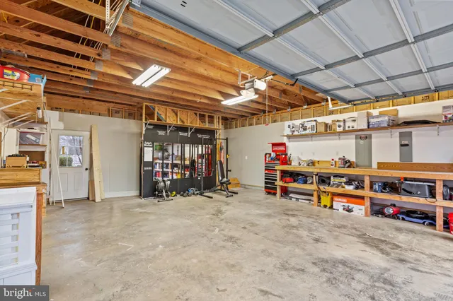 a view of entryway with a front door and wooden floor