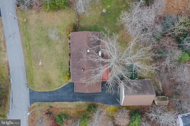 a view of a house with a yard and sitting area