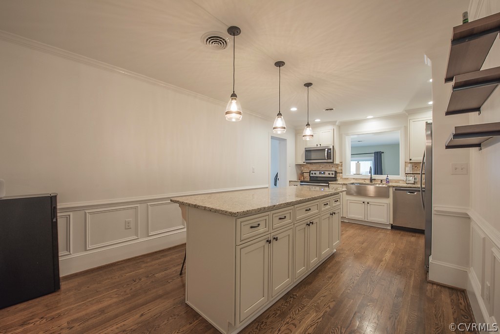 8008 Dunsmore Road Henrico, VA 23229 - Photo 24 of 46 a kitchen with white cabinets appliances and wooden floor
