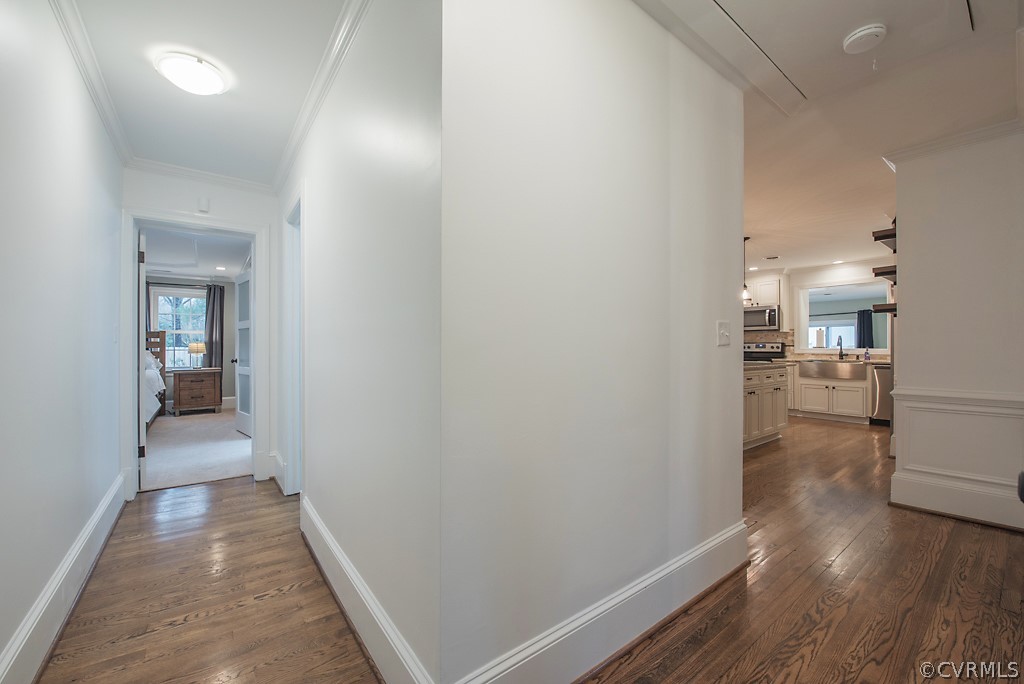 8008 Dunsmore Road Henrico, VA 23229 - Photo 26 of 46 a view of a hallway with wooden floor a fireplace and a bathroom