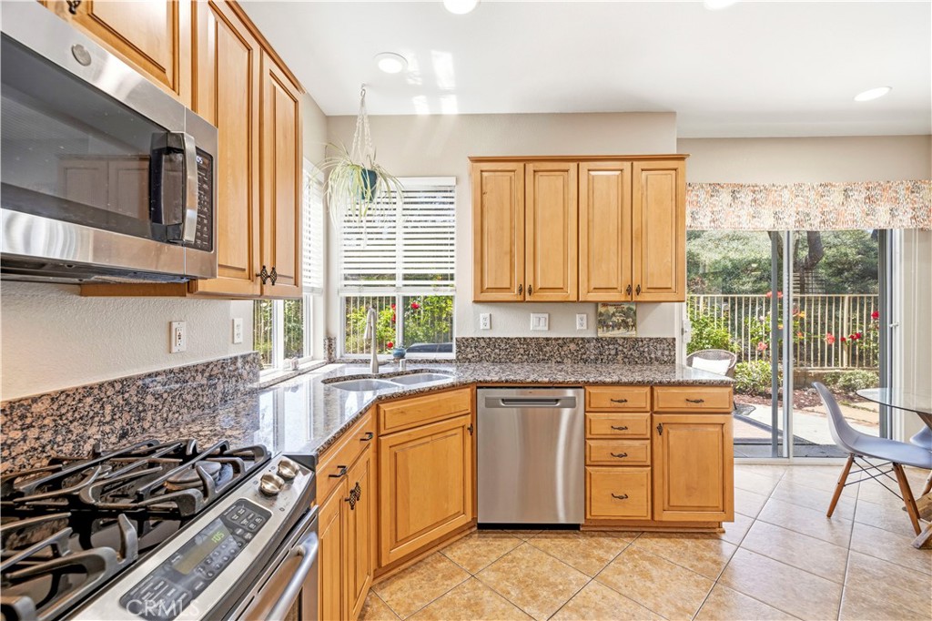 28033 Memory Lane Valencia, CA 91354 - Photo 12 of 40 a kitchen with a stove a sink and a refrigerator