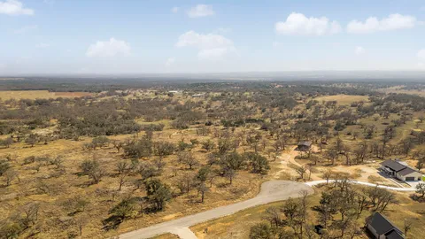 an aerial view of house with yard and mountain in the back