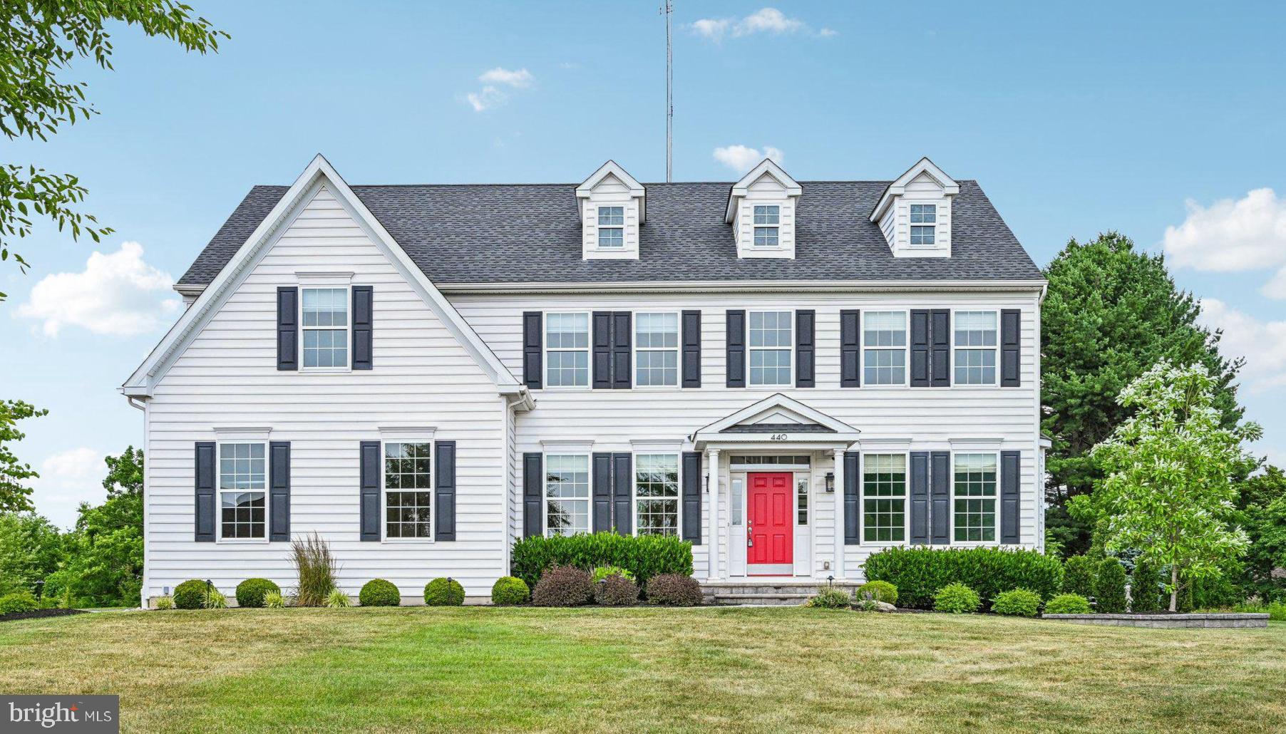 Charming home with vibrant red door.