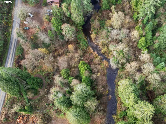 an aerial view of a house with yard and outdoor seating