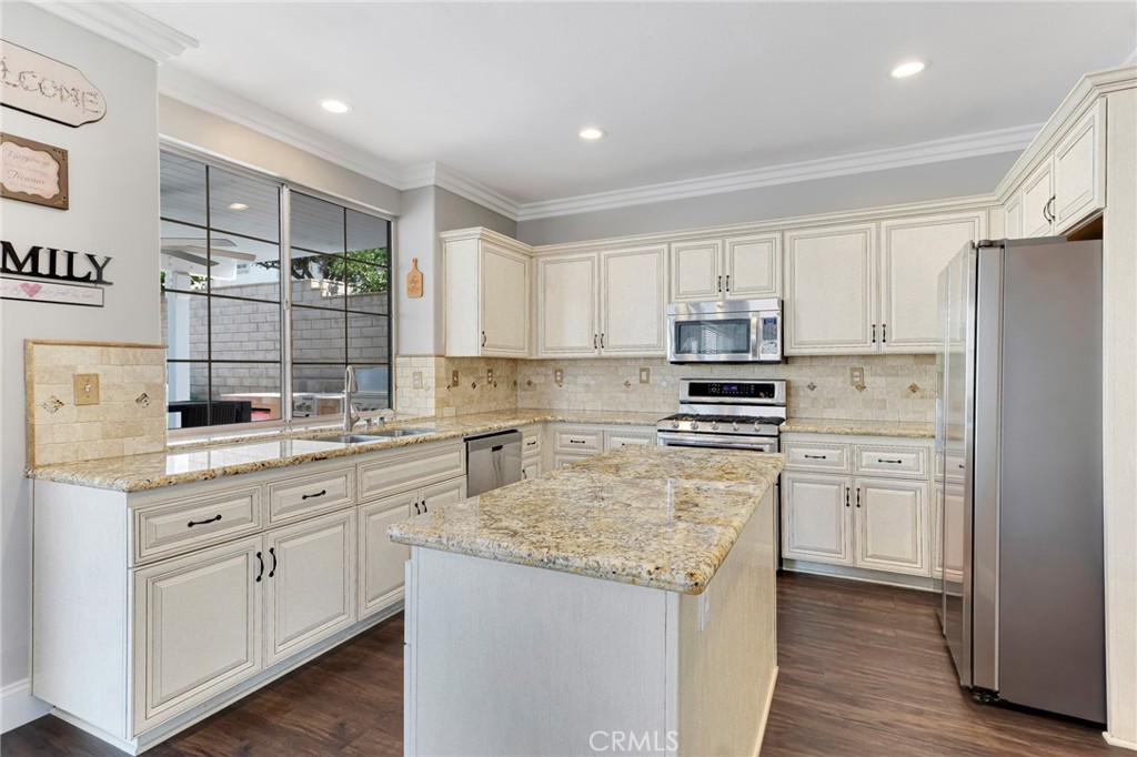 2702 Titania Place Simi Valley, CA 93063 - Photo 12 of 38 a kitchen with stainless steel appliances granite countertop a stove a sink and a refrigerator
