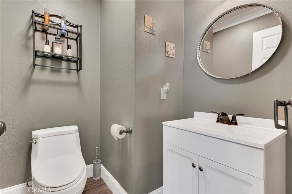 2702 Titania Place Simi Valley, CA 93063 - Photo 15 of 38 a bathroom with a toilet a sink and a mirror