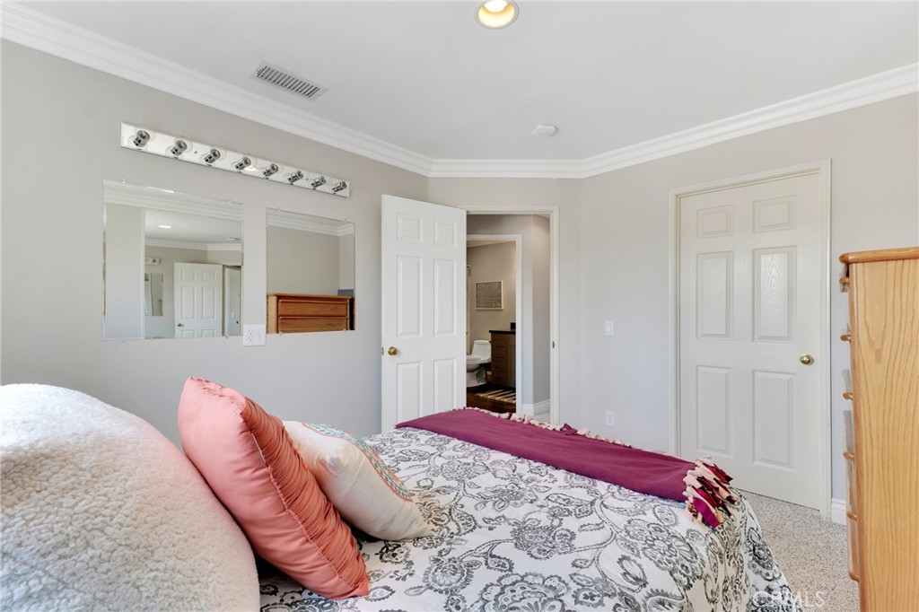 2702 Titania Place Simi Valley, CA 93063 - Photo 22 of 38 a bedroom with a bed and a chandelier
