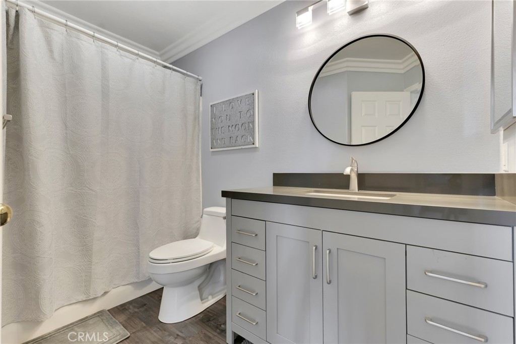 2702 Titania Place Simi Valley, CA 93063 - Photo 23 of 38 a bathroom with a sink a mirror and a toilet