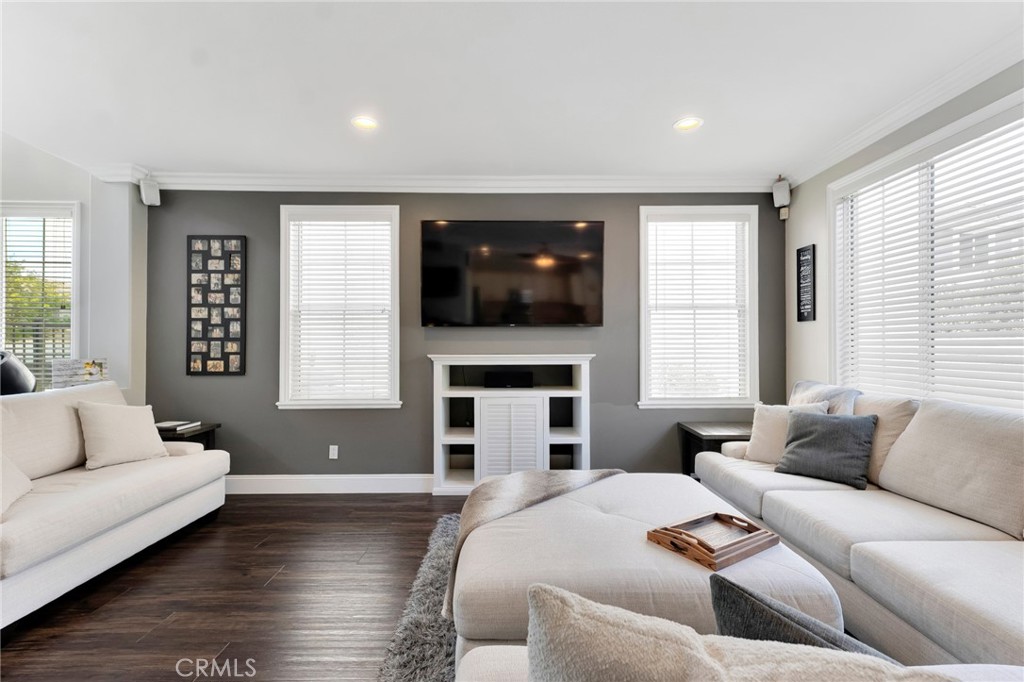 2702 Titania Place Simi Valley, CA 93063 - Photo 7 of 38 a living room with furniture a flat screen tv and a fireplace