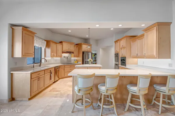a large kitchen with a table and chairs