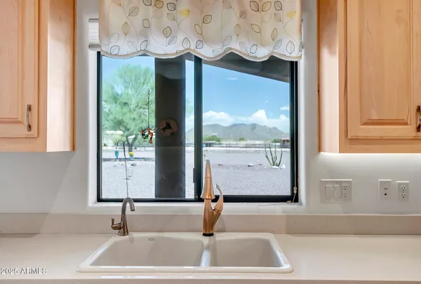 a bathroom with mirror and window