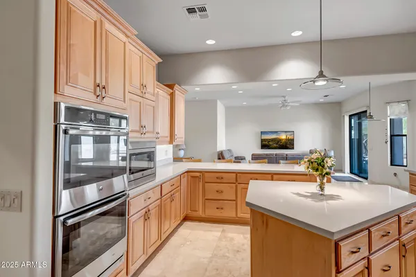 a kitchen with stainless steel appliances a sink and a refrigerator