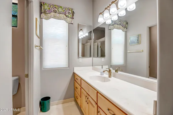 a bathroom with a sink double vanity and a mirror