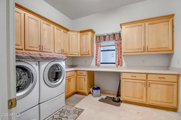 a utility room with sink dryer and washer