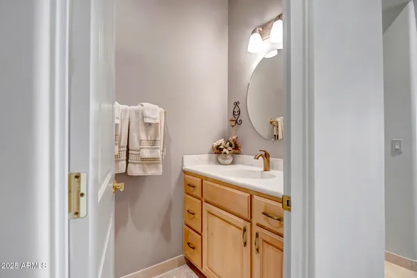 a en suite bathroom with a sink vanity and mirror