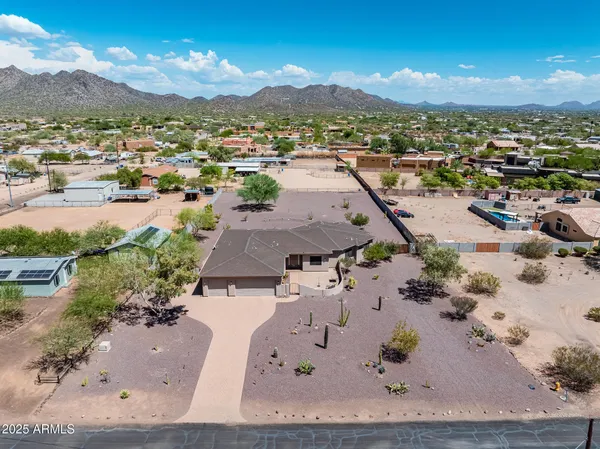 an aerial view of residential houses with outdoor space