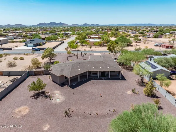 an aerial view of residential houses with city view