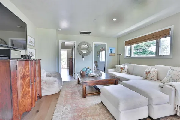 a living room with furniture and wooden floor