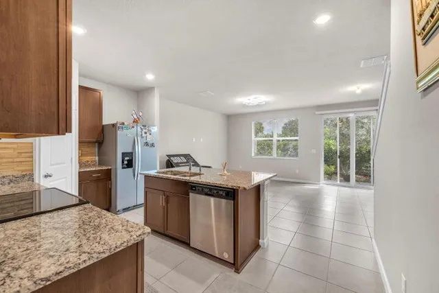 a kitchen with a sink stove and refrigerator