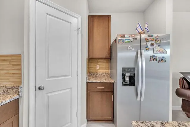 a room with refrigerator and washer