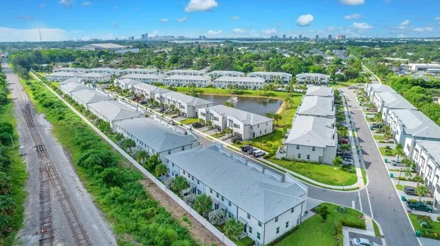 an aerial view of a house with a garden and lake view