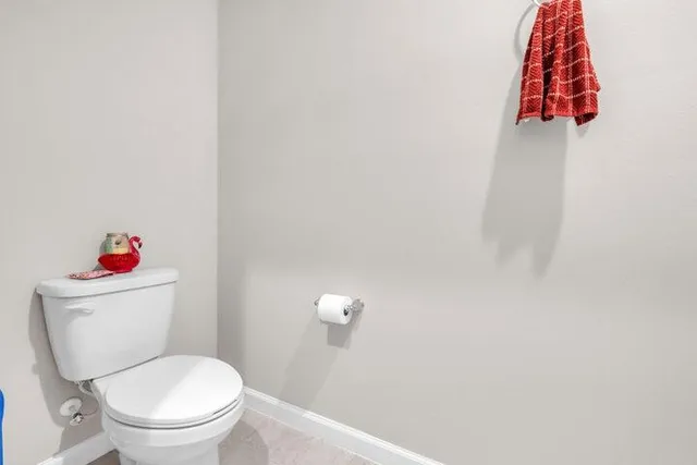 a white toilet sitting next to a bathroom sink