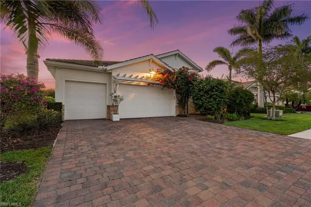 a view of a house with a yard and garage
