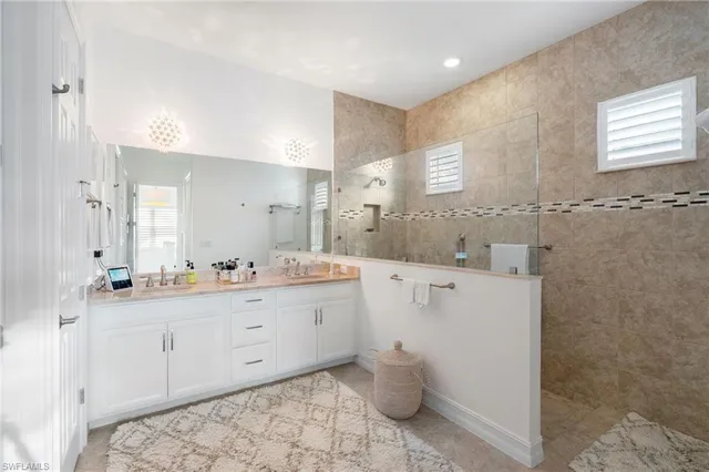 a spacious bathroom with a granite countertop sink mirror and a toilet