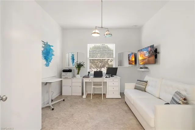 a living room with furniture a window and a flat screen tv